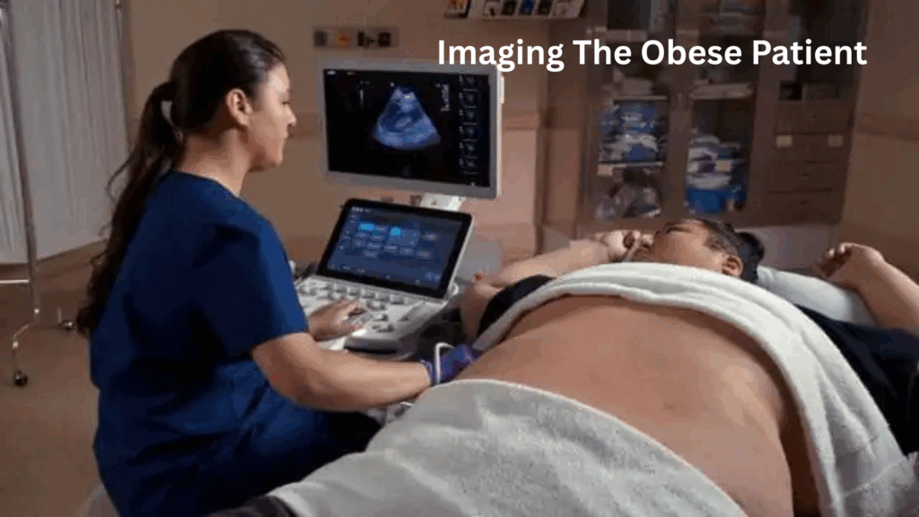 Obesity: A healthcare professional, performs an ultrasound scan on an obese patient lying on an exam table. The patient’s abdomen is exposed and covered partially with a white towel. An ultrasound image is visible on the monitor. The setting appears to be a medical examination room. White text in the top right corner reads: “Imaging The Obese Patient.